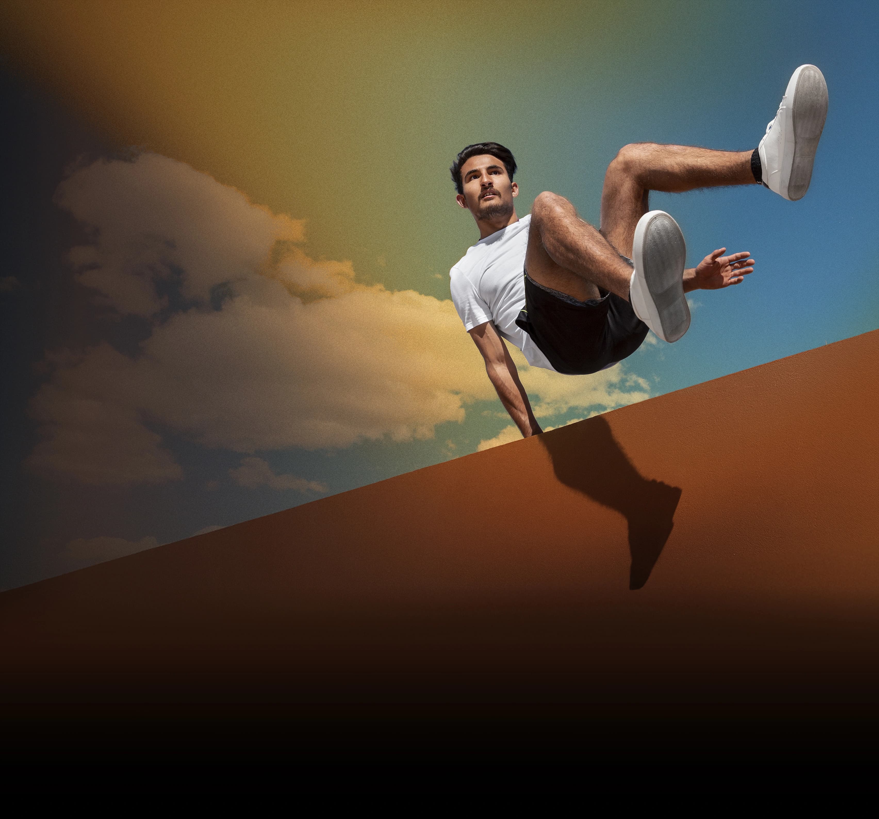 Person jumping against dramatic sky